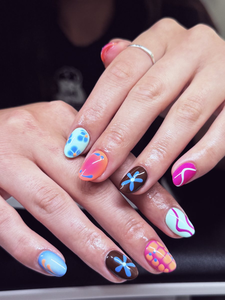 Mismatched Gel X set with bright flowers, dots and swirls